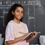 woman in pink crew neck t shirt holding notepad