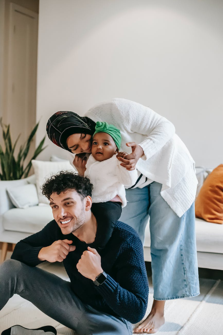 happy multiracial family with cute daughter spending time together at home