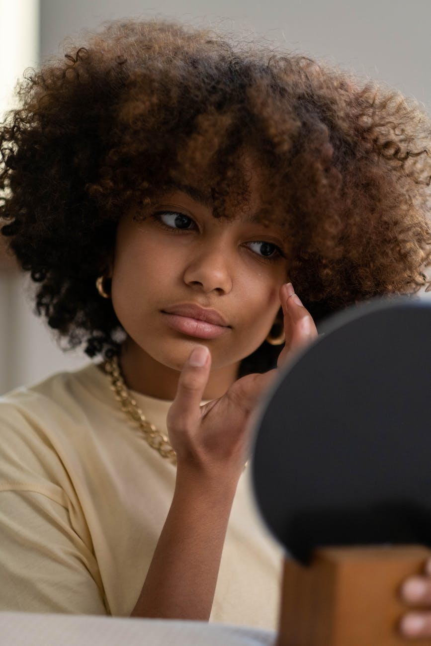 woman looking at a mirror