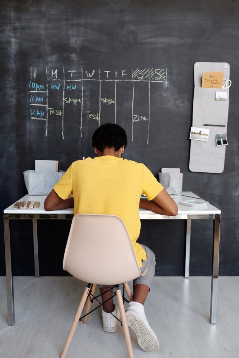 boy in yellow crew neck t shirt sitting on chair