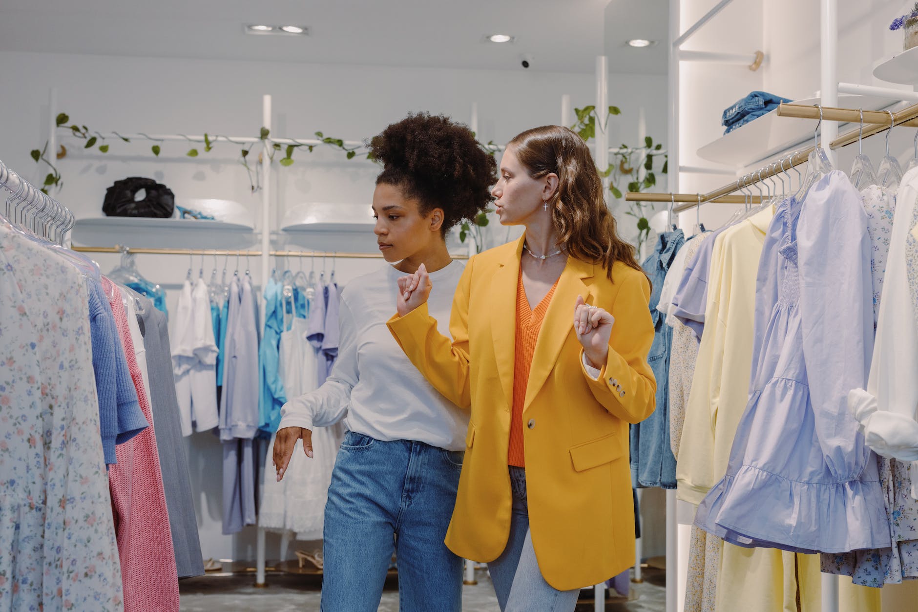 woman in yellow blazer standing beside woman in yellow blazer