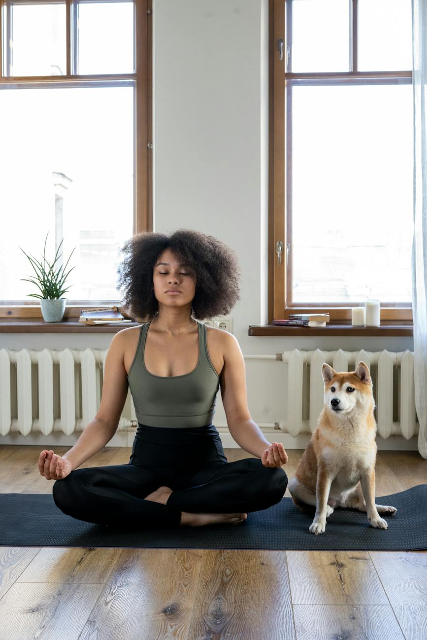 woman meditating beside her dog