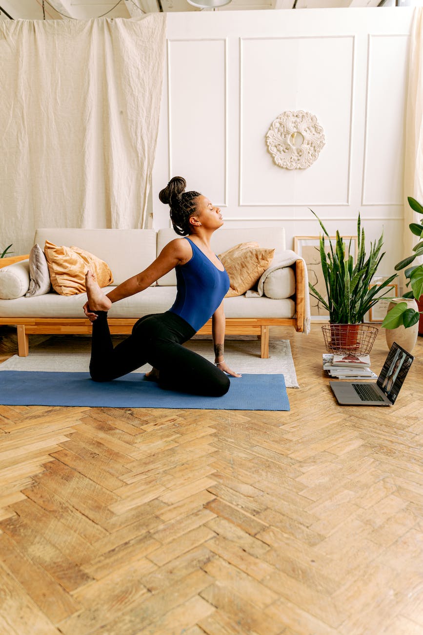 a woman in blue tank top doing a yoga