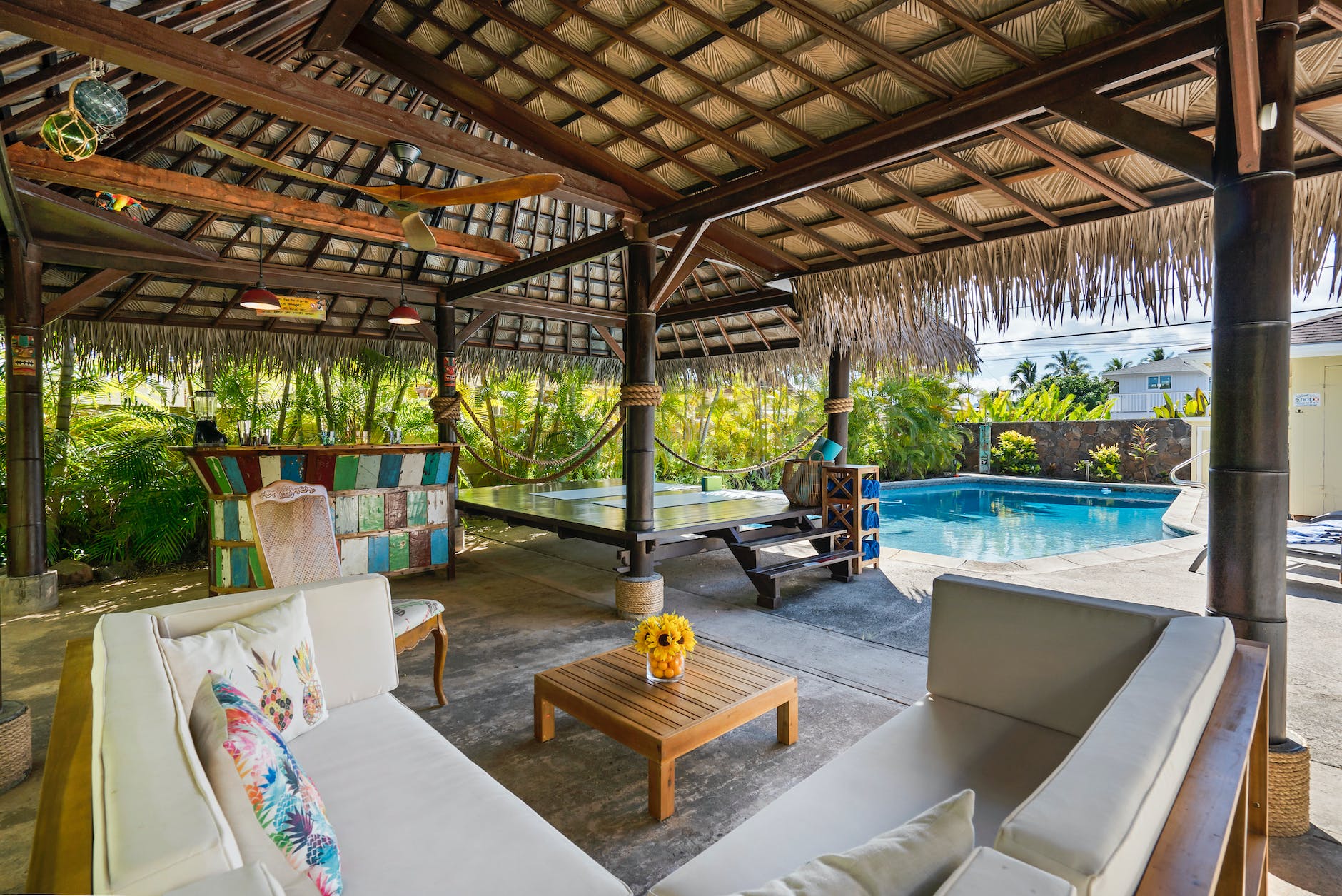 a cozy cabana close to a swimming pool