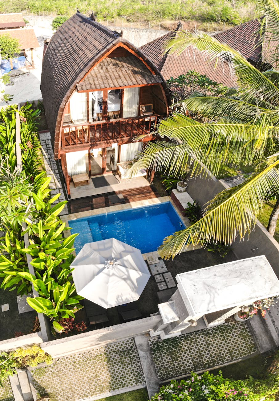 brown wooden house with pool