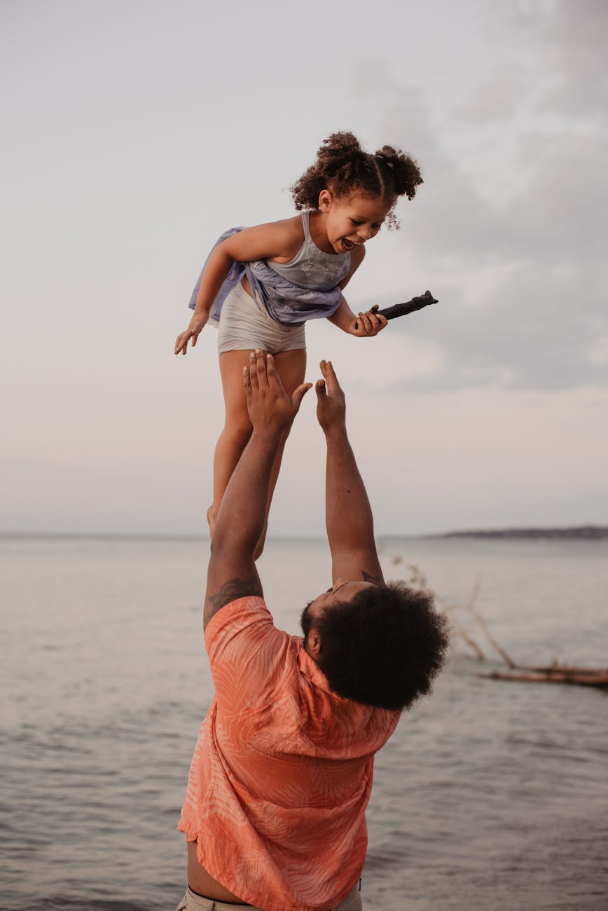 father and child having fun on the beach