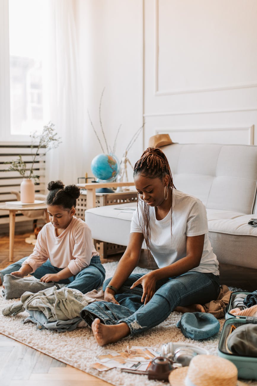 child and woman folding clean clothes