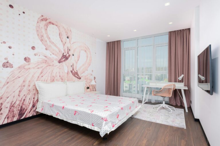 spacious bedroom with flamingos on walls