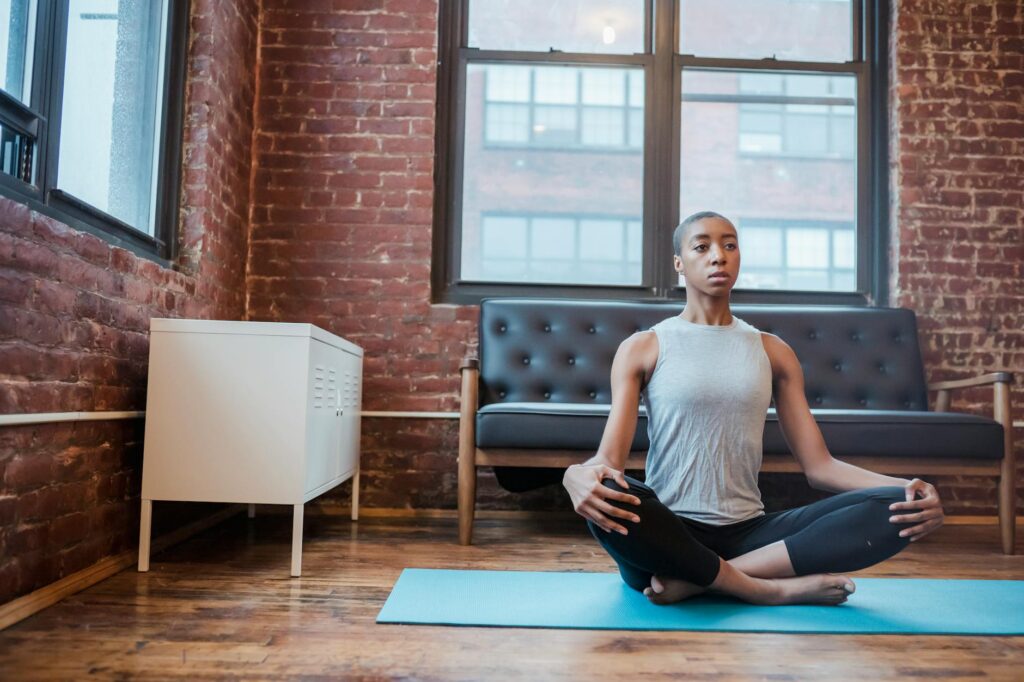 focused black woman practicing easy sit posture