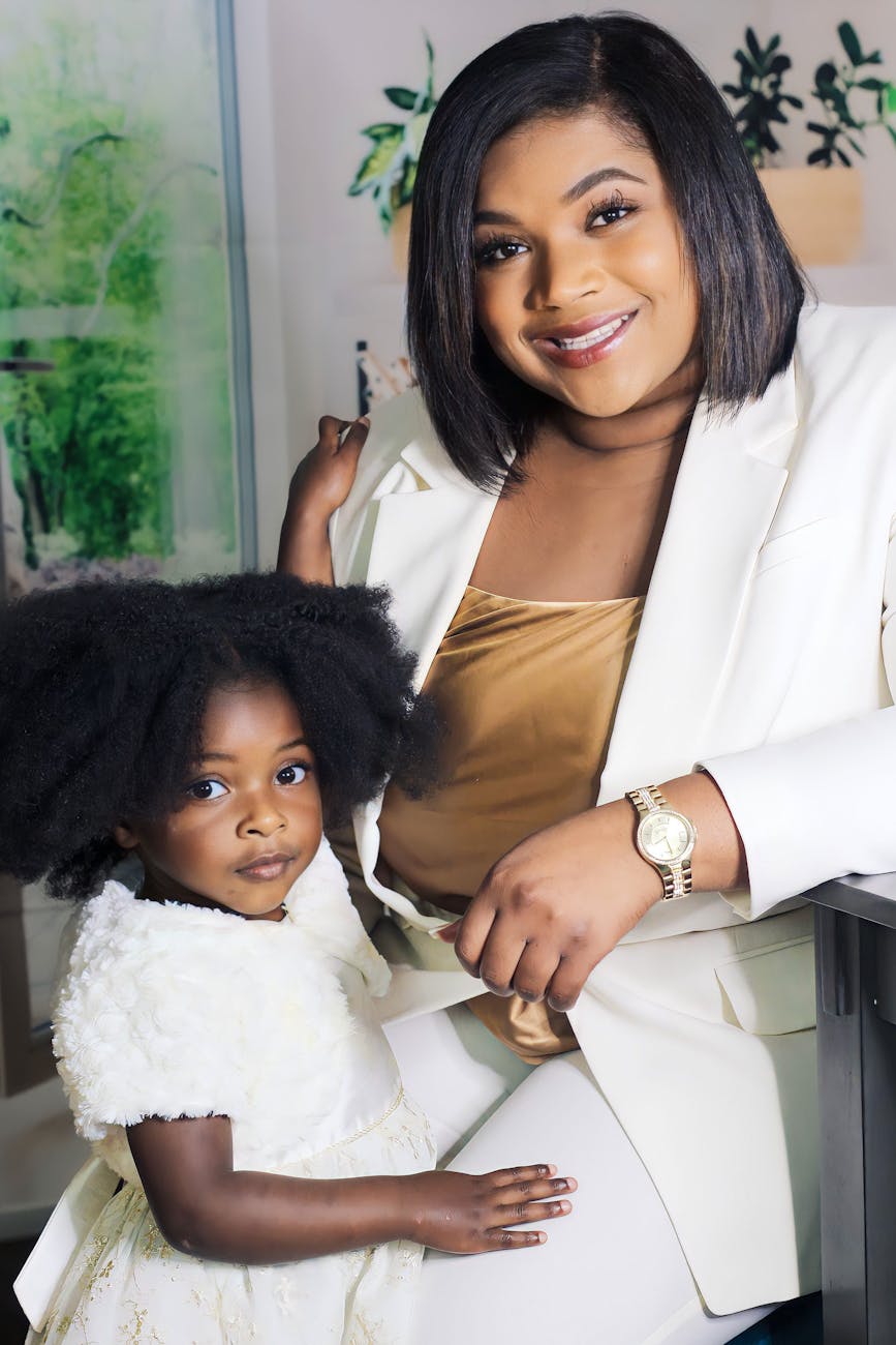 smiling woman in white with girl in white