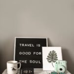 teal fujifilm instax mini camera near white ceramic mug