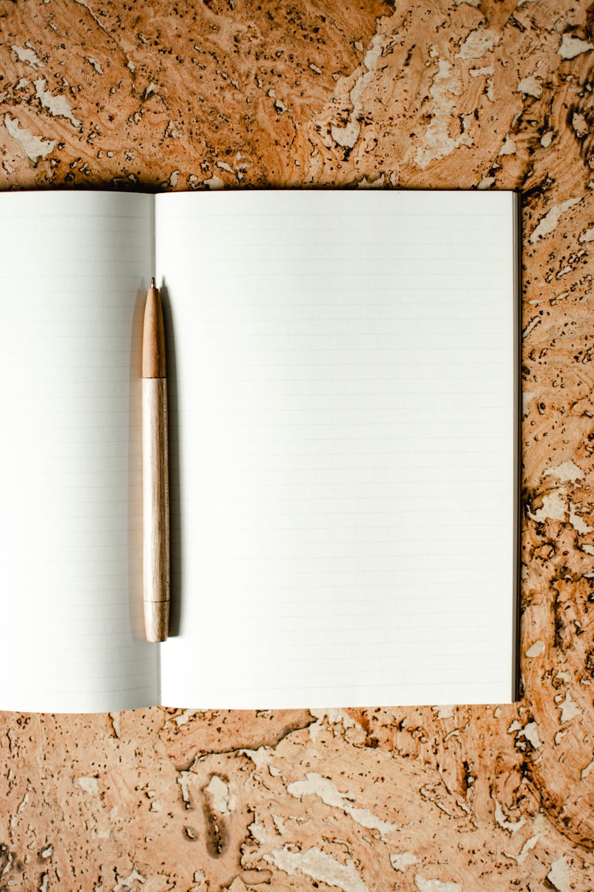 pen in an opened blank notebook