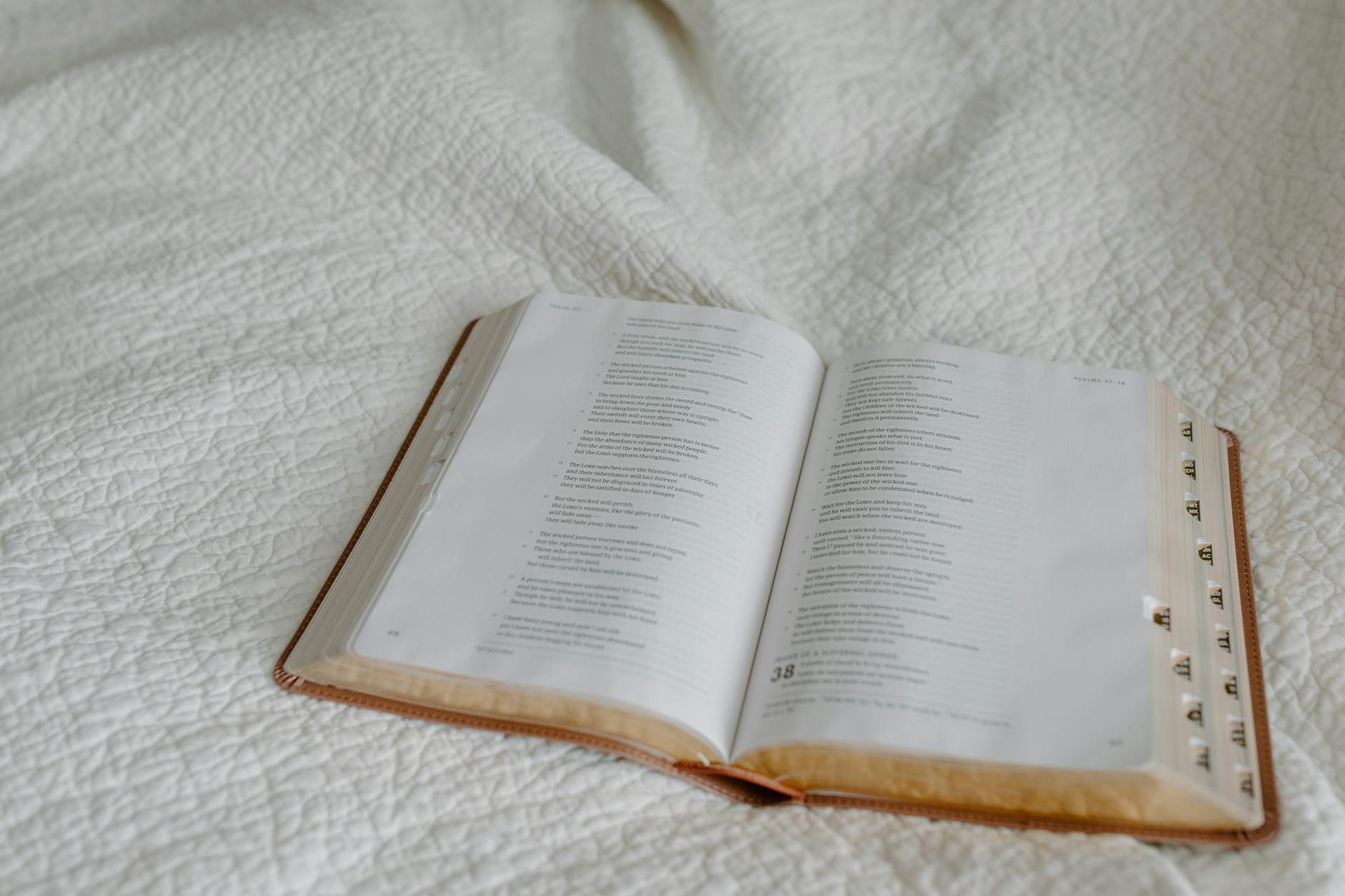 open book on white linen